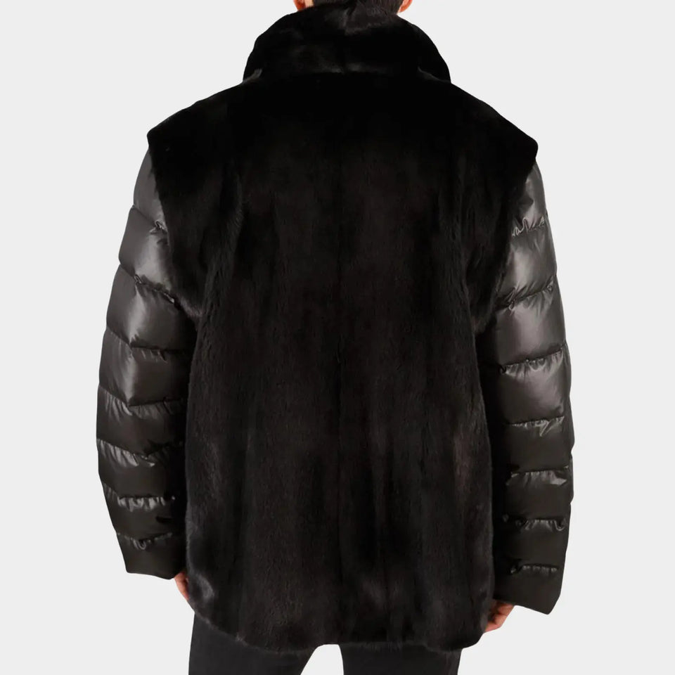 Black puffer jacket with fur trim on a white background