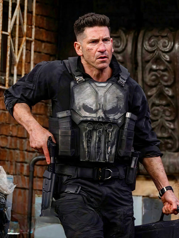Man wearing a black Punisher skull tactical vest with utility belt and pouches in a street scene