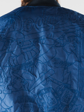 Close-up of stitched Ohtani number 17 and Dodgers championship ring embroidery on the back of a blue bomber jacket