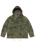 Front view of the green tie-dye field jacket with the removable hood attached and up.