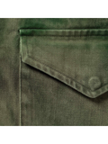 Close-up detail of the green tie-dye fabric and stitched flap pocket.