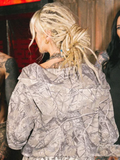 Back view close-up of model wearing treecamo zip-up hoodie showing hood and fabric texture